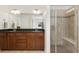 Bathroom features dual sinks with dark granite countertops and a glass enclosed shower at 2856 Shadow Lake Rd, Lafayette, CO 80026