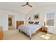 Bright bedroom features a neutral color palette, a ceiling fan, and ample natural light from the two windows at 2856 Shadow Lake Rd, Lafayette, CO 80026