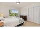 Bedroom featuring a comfortable bed, a dresser, and a window with scenic views of trees at 2856 Shadow Lake Rd, Lafayette, CO 80026