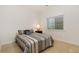 Cozy bedroom featuring a comfortable bed with decorative pillows and a side table with a lamp at 2856 Shadow Lake Rd, Lafayette, CO 80026