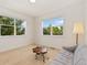 Bright bedroom with ample natural light, featuring neutral colors and a cozy sitting area by the windows at 2856 Shadow Lake Rd, Lafayette, CO 80026