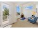 Versatile room features a walk out balcony, neutral carpets, comfortable seating, and large windows at 2856 Shadow Lake Rd, Lafayette, CO 80026