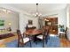 Elegant dining room showcasing an oversized wooden table, hardwood floors, and natural light streaming in at 2856 Shadow Lake Rd, Lafayette, CO 80026