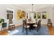 Bright dining room with large windows and a stylish chandelier, perfect for gatherings and meals at 2856 Shadow Lake Rd, Lafayette, CO 80026