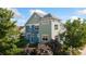 View of the home's exterior showcasing its lush landscaping, dual-tone paint scheme and architectural design at 2856 Shadow Lake Rd, Lafayette, CO 80026