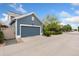 Detached two-car garage with a driveway and well-maintained landscaping, providing ample parking at 2856 Shadow Lake Rd, Lafayette, CO 80026