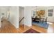 Bright hallway with hardwood floors leading to a dining room with elegant decor at 2856 Shadow Lake Rd, Lafayette, CO 80026