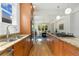 Open kitchen featuring hardwood floors, granite counters, stainless appliances, and a view into the adjacent dining room at 2856 Shadow Lake Rd, Lafayette, CO 80026