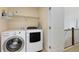 Laundry room with white washer, dryer, and a shelf for storing supplies at 2856 Shadow Lake Rd, Lafayette, CO 80026