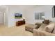 Comfortable living room features a plush sectional sofa, ottoman, and modern entertainment center at 2856 Shadow Lake Rd, Lafayette, CO 80026