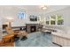 Cozy living room featuring a stone fireplace, plush seating, and plenty of natural light from large windows at 2856 Shadow Lake Rd, Lafayette, CO 80026