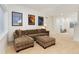 Cozy living area with a sectional sofa, ottoman, and framed art prints, perfect for relaxing at 2856 Shadow Lake Rd, Lafayette, CO 80026