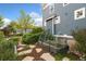 Landscaped yard featuring a raised garden bed, stone pathway, and lush greenery at 2856 Shadow Lake Rd, Lafayette, CO 80026