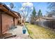 Spacious backyard with patio, lawn, and mature trees, perfect for relaxation at 9720 W Kentucky Dr, Lakewood, CO 80226