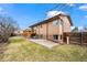 Backyard featuring a patio, wooden deck, and mature trees at 9720 W Kentucky Dr, Lakewood, CO 80226