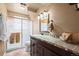 Bathroom with updated vanity, framed mirror, shower, and neutral wall color at 9720 W Kentucky Dr, Lakewood, CO 80226