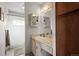 Cozy bathroom featuring a shower, vanity with storage, and neutral-toned walls at 9720 W Kentucky Dr, Lakewood, CO 80226