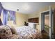 Inviting bedroom with desk, shelves, and a floral bedspread at 9720 W Kentucky Dr, Lakewood, CO 80226