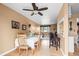 Dining area featuring hardwood floors, a ceiling fan, and an open layout into the living room at 9720 W Kentucky Dr, Lakewood, CO 80226