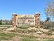 Addenbrooke Park stone entrance sign at 600 South Kipling with colorful landscaping and blue skies at 9720 W Kentucky Dr, Lakewood, CO 80226