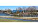 Pondside view of blue gazebos, playground, a stone shoreline, and water feature in a tranquil green park at 9720 W Kentucky Dr, Lakewood, CO 80226