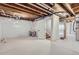 Unfinished basement ready for customization, with exposed beams and freshly painted floors at 3420 N Steele St, Denver, CO 80205