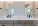 Contemporary bathroom with double vanity featuring stone countertops, stylish fixtures, and large mirrors at 3420 N Steele St, Denver, CO 80205