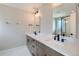 Sleek bathroom featuring double sinks, quartz counters, dark hardware, and a glass-enclosed shower for a spa-like feel at 3420 N Steele St, Denver, CO 80205