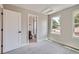 Bright bedroom features neutral walls, plush carpeting, and an ensuite bathroom with great natural light at 3420 N Steele St, Denver, CO 80205