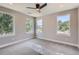 Light-filled bedroom with three large windows, ceiling fan, plush carpet, and neutral walls creating a bright, airy atmosphere at 3420 N Steele St, Denver, CO 80205