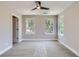 Spacious bedroom features neutral walls, plush carpet, ceiling fan, and ample natural light from multiple windows at 3420 N Steele St, Denver, CO 80205