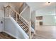 Stylish staircase showcases wood treads, black metal railings, and leads to an open-concept living space at 3420 N Steele St, Denver, CO 80205