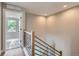 Modern staircase with sleek metal railings and light wood steps leading to the upper level at 3420 N Steele St, Denver, CO 80205