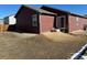 A view of the home's spacious backyard featuring brown grass and partial view of adjacent homes at 2003 Monte Vista Dr, Lochbuie, CO 80603