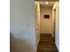 Well-lit hallway with hardwood floors connecting different areas of the home at 2003 Monte Vista Dr, Lochbuie, CO 80603