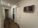 Clean hallway with light paint, modern art, and hardwood floors at 2003 Monte Vista Dr, Lochbuie, CO 80603