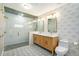 Bright bathroom with modern finishes, dual vanities, patterned floor, and glass shower at 4258 Tennyson St, Denver, CO 80212