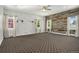 Spacious bedroom with stylish wallpaper, wood accent wall, and ample natural light at 4258 Tennyson St, Denver, CO 80212