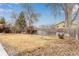 Expansive backyard featuring mature trees and a sturdy wooden fence at 430 Aspen Ct, Broomfield, CO 80020