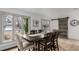 Bright and airy dining room with a large window and stylish wooden table and chairs at 430 Aspen Ct, Broomfield, CO 80020