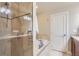 Bathroom featuring a luxurious soaking tub and glass-enclosed shower at 2700 E Louisiana Ave # 203, Denver, CO 80210
