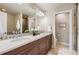 Bathroom featuring double sinks and a large mirror at 2700 E Louisiana Ave # 203, Denver, CO 80210