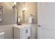 Well-lit powder room featuring modern fixtures and neutral colors at 2700 E Louisiana Ave # 203, Denver, CO 80210