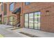 Modern building facade featuring large windows, brick, and front access at 2700 E Louisiana Ave # 203, Denver, CO 80210