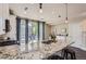 Bright kitchen with granite countertops and a sliding door leading to an outdoor balcony at 2700 E Louisiana Ave # 203, Denver, CO 80210