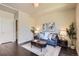 Comfortable living room with stylish furniture, dark hardwood floors, and contemporary wall art at 2700 E Louisiana Ave # 203, Denver, CO 80210