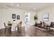 Open-concept living and dining area with dark wood floors, neutral tones, and modern decor at 2700 E Louisiana Ave # 203, Denver, CO 80210