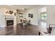 Cozy space showcasing a fireplace, dining table, dark wood floors and bright, neutral walls at 2700 E Louisiana Ave # 203, Denver, CO 80210