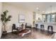 Inviting living area featuring modern seating, dark wood floors, and a breakfast bar to the kitchen at 2700 E Louisiana Ave # 203, Denver, CO 80210
