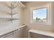 Organized walk-in closet with multiple shelves and a window for natural light at 2700 E Louisiana Ave # 203, Denver, CO 80210